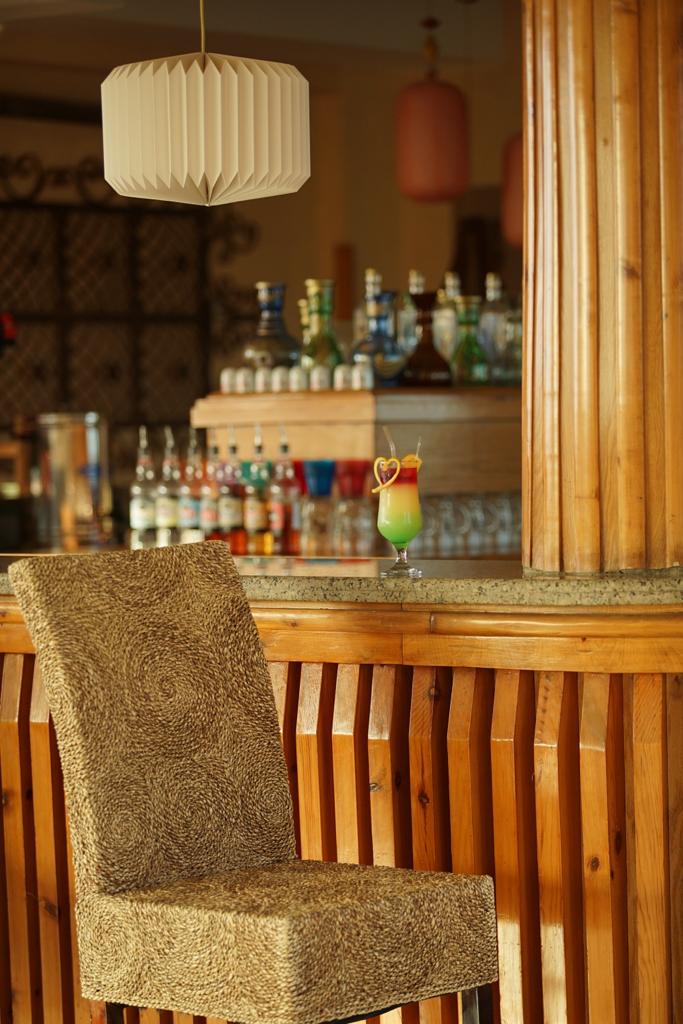 Bar with cocktail and woven rattan stool
