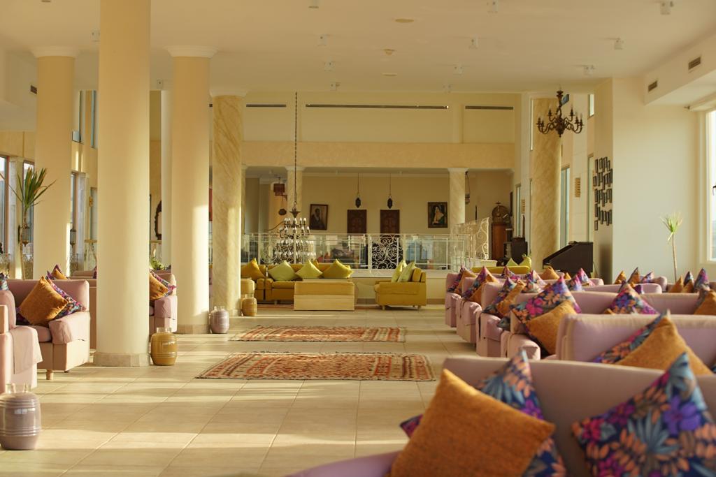 Lobby with marble pillars and pastel armchairs