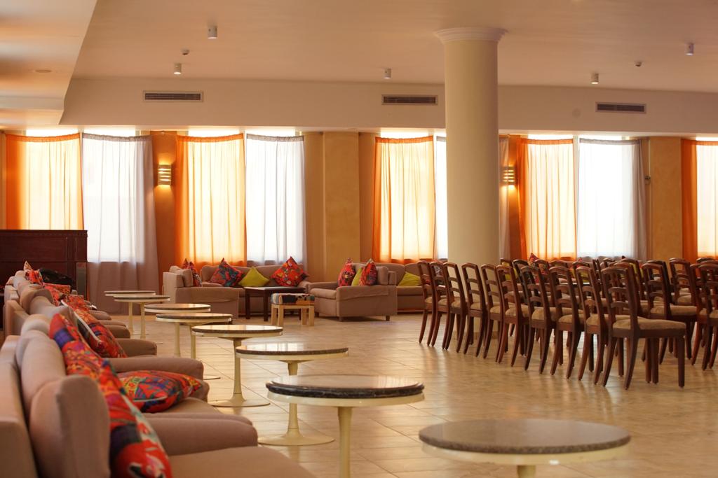 Spacious lounge hall with sofas and curtained windows